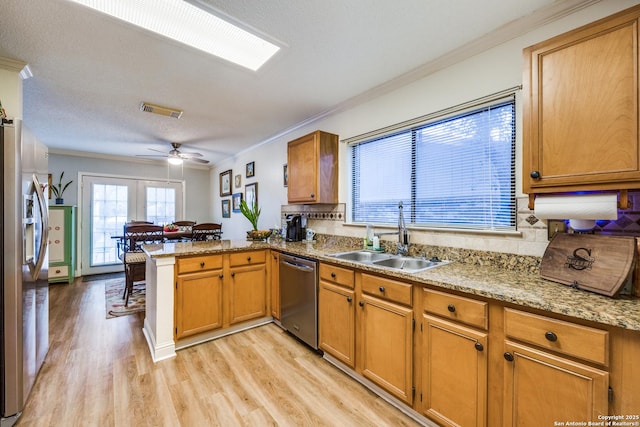 9618 Alderwood, San Antonio, TX 78250 - kitchen featuring stainless steel appliances, a sink, a peninsula, ornamental molding, and light wood finished floors