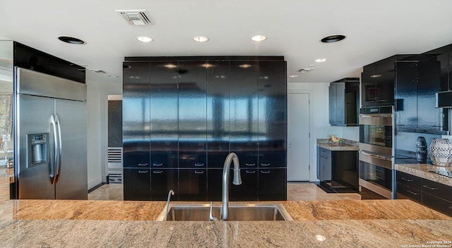 7887 Broadway Unit 1102, San Antonio, TX 78209 - kitchen with a sink, dark cabinets, stainless steel appliances, light stone countertops, and recessed lighting