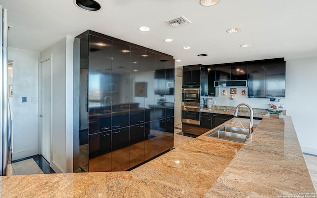 7887 Broadway Unit 1102, San Antonio, TX 78209 - kitchen with dark cabinetry, modern cabinets, a sink, recessed lighting, and baseboards