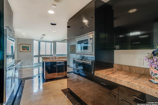 7887 Broadway Unit 1102, San Antonio, TX 78209 - kitchen featuring stainless steel appliances, modern cabinets, dark cabinetry, and recessed lighting