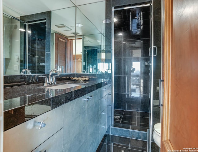 7887 Broadway Unit 1102, San Antonio, TX 78209 - bathroom featuring a shower stall, vanity, and toilet