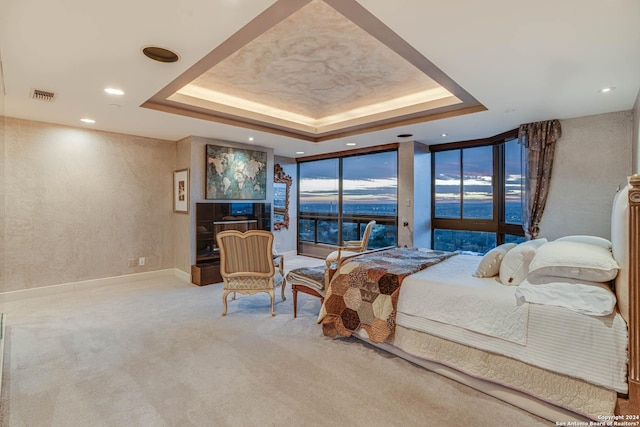 7887 Broadway Unit 1102, San Antonio, TX 78209 - bedroom with a raised ceiling, carpet, recessed lighting, a textured wall, and floor to ceiling windows