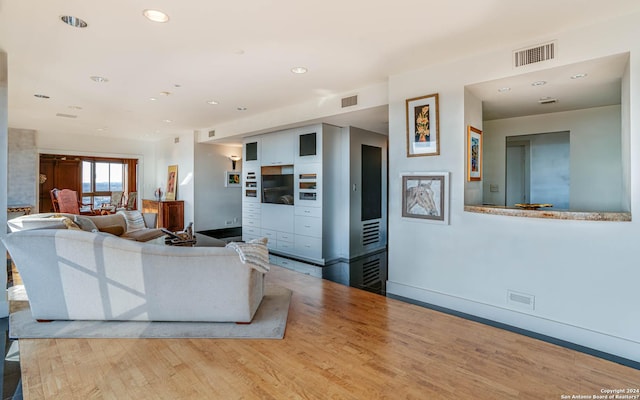 7887 Broadway Unit 1102, San Antonio, TX 78209 - living area with wood finished floors, baseboards, and recessed lighting