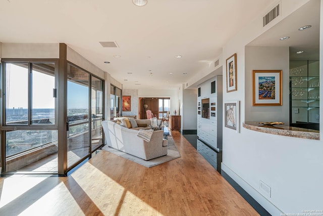 7887 Broadway Unit 1102, San Antonio, TX 78209 - living area with wood finished floors, baseboards, and recessed lighting
