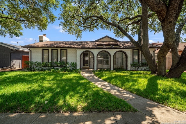 424 Fenwick Dr, Windcrest, TX 78239 - ranch-style home with brick siding, a front lawn, and a chimney