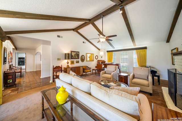 424 Fenwick Dr, Windcrest, TX 78239 - living area with arched walkways, a ceiling fan, a fireplace, a textured ceiling, and baseboards