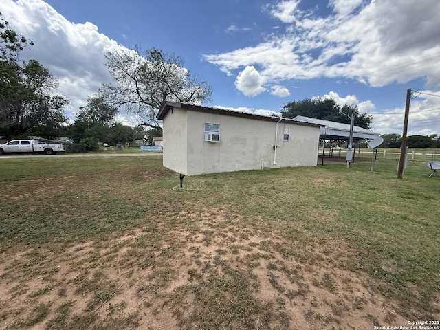 13338 Interstate 35, Moore, TX 78057 - view of side of property featuring stucco siding and a lawn