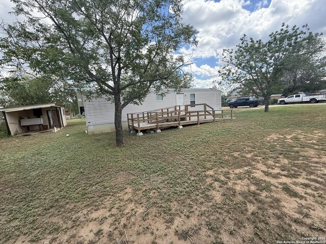 13338 Interstate 35, Moore, TX 78057 - view of green lawn with a wooden deck