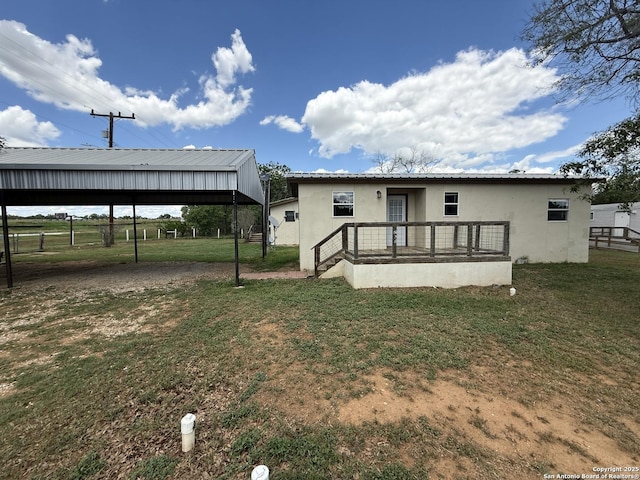 13338 Interstate 35, Moore, TX 78057 - back of house featuring a lawn, stucco siding, and metal roof