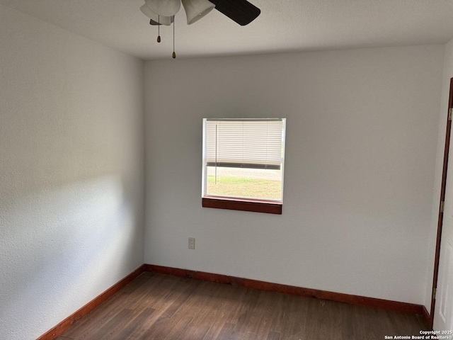 13338 Interstate 35, Moore, TX 78057 - spare room featuring a ceiling fan, dark wood-style flooring, and baseboards