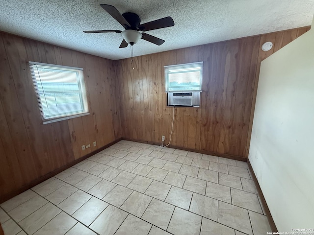 13338 Interstate 35, Moore, TX 78057 - empty room featuring a ceiling fan, a textured ceiling, cooling unit, wood walls, and a smoke detector