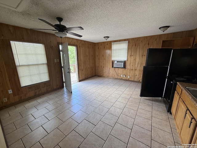 13338 Interstate 35, Moore, TX 78057 - unfurnished living room featuring a ceiling fan, wooden walls, a textured ceiling, baseboards, and light tile patterned flooring