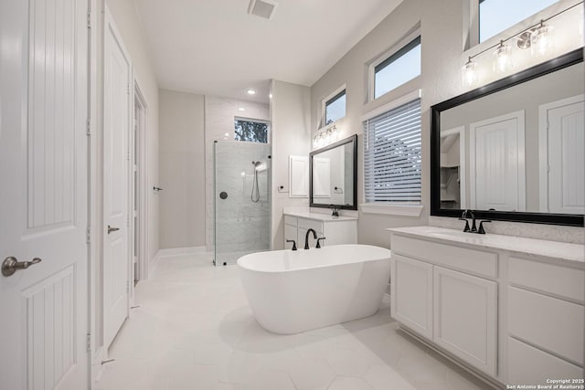 557 Poe Pkwy, Castroville, TX 78009 - full bathroom with a stall shower, vanity, a freestanding bath, and recessed lighting
