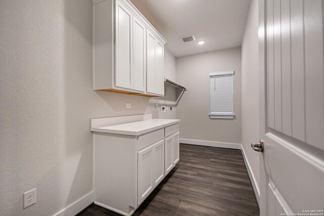 557 Poe Pkwy, Castroville, TX 78009 - laundry room with baseboards, cabinet space, dark wood finished floors, and recessed lighting