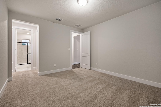 557 Poe Pkwy, Castroville, TX 78009 - unfurnished bedroom with carpet, baseboards, and a textured ceiling