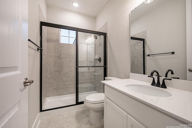 557 Poe Pkwy, Castroville, TX 78009 - bathroom with toilet, a stall shower, tile patterned flooring, vanity, and a textured wall