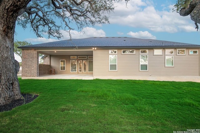 557 Poe Pkwy, Castroville, TX 78009 - rear view of house with a patio and a lawn