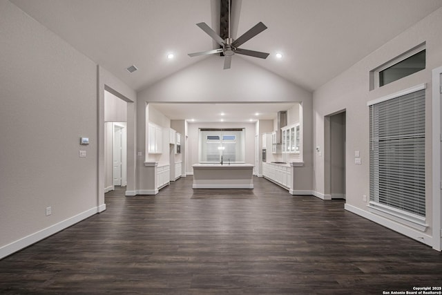 557 Poe Pkwy, Castroville, TX 78009 - unfurnished living room featuring ceiling fan, dark wood-style floors, recessed lighting, baseboards, and high vaulted ceiling