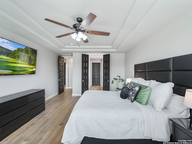 126 Stout Cv, Cibolo, TX 78108 - bedroom with a tray ceiling, wood finished floors, baseboards, and ceiling fan