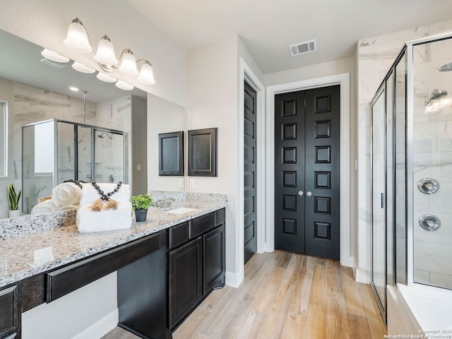 126 Stout Cv, Cibolo, TX 78108 - full bathroom with wood finished floors, a shower stall, vanity, and baseboards