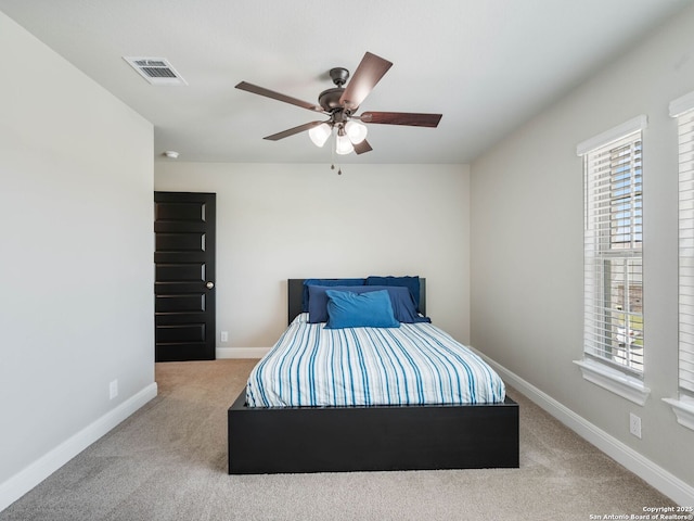 126 Stout Cv, Cibolo, TX 78108 - bedroom with multiple windows, carpet floors, baseboards, and a ceiling fan