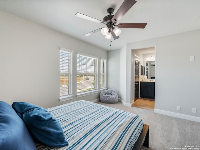 126 Stout Cv, Cibolo, TX 78108 - bedroom with light colored carpet, baseboards, connected bathroom, and ceiling fan