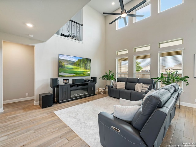 126 Stout Cv, Cibolo, TX 78108 - living room with a ceiling fan, baseboards, plenty of natural light, wood finished floors, and a high ceiling