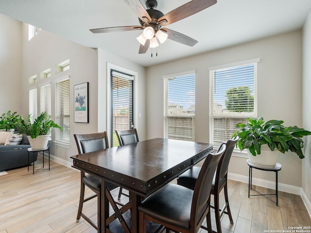 126 Stout Cv, Cibolo, TX 78108 - dining room featuring baseboards, light wood finished floors, and a ceiling fan