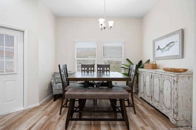111 Great Chagos, Rockport, TX 78382 - dining area with a chandelier, light wood-style flooring, and baseboards