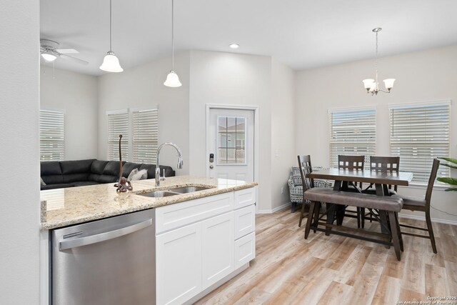 111 Great Chagos, Rockport, TX 78382 - kitchen with stainless steel dishwasher, a sink, a ceiling fan, light stone counters, and light wood-style flooring