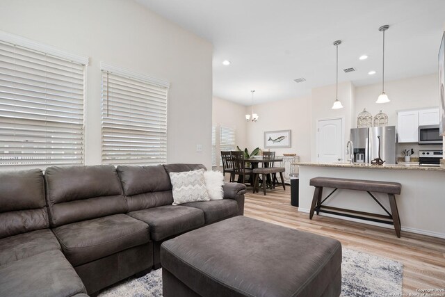 111 Great Chagos, Rockport, TX 78382 - living room with light wood-type flooring, a chandelier, and recessed lighting