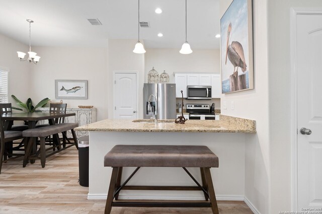 111 Great Chagos, Rockport, TX 78382 - kitchen featuring appliances with stainless steel finishes, a peninsula, hanging light fixtures, a sink, and recessed lighting