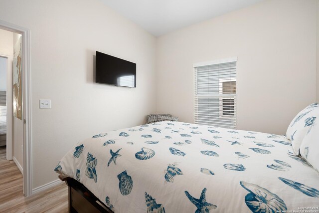 111 Great Chagos, Rockport, TX 78382 - bedroom with light wood-style floors and baseboards