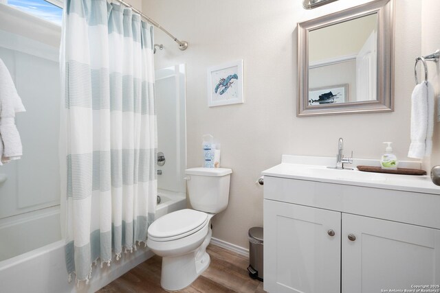 111 Great Chagos, Rockport, TX 78382 - bathroom featuring shower / tub combo, wood finished floors, toilet, vanity, and baseboards