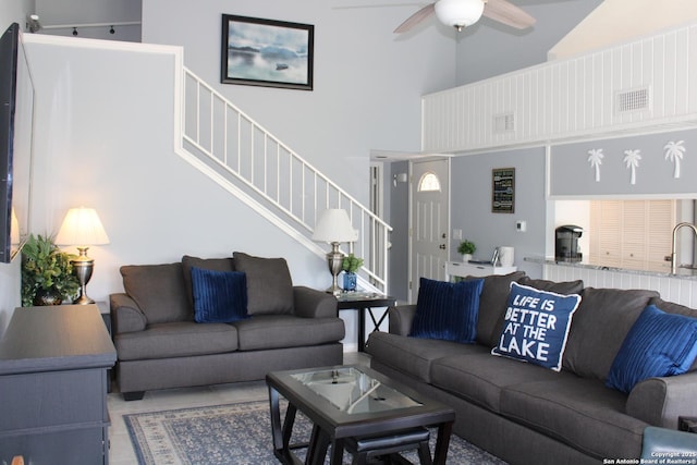 104 Horseshoe Bay Unit 5, Horseshoe Bay, TX 78657 - living area featuring stairs, a towering ceiling, and a ceiling fan