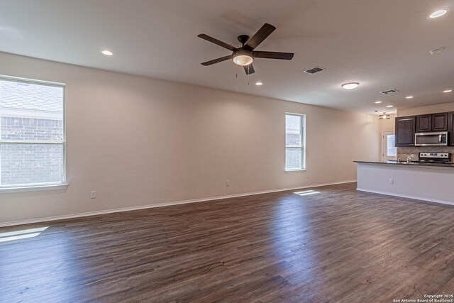 2733 Barkey Spg, San Antonio, TX 78245 - unfurnished living room with a ceiling fan, dark wood-type flooring, baseboards, and recessed lighting