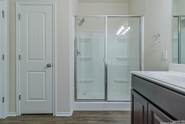 2733 Barkey Spg, San Antonio, TX 78245 - full bath featuring a shower stall, wood finished floors, a textured wall, and vanity