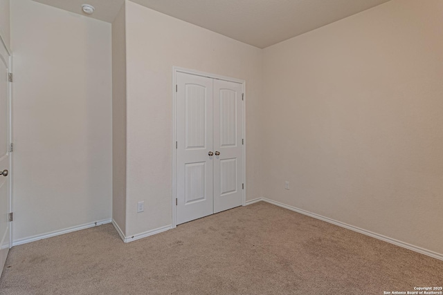 2733 Barkey Spg, San Antonio, TX 78245 - unfurnished bedroom with light colored carpet, baseboards, and a closet