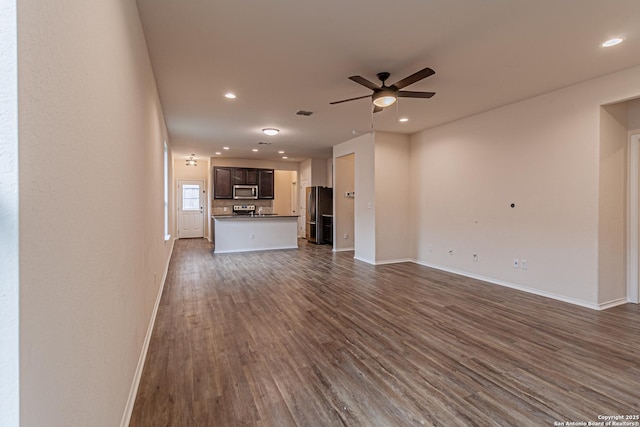 2733 Barkey Spg, San Antonio, TX 78245 - unfurnished living room with ceiling fan, dark wood-type flooring, baseboards, and recessed lighting