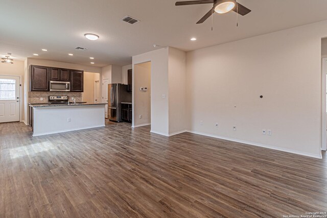 2733 Barkey Spg, San Antonio, TX 78245 - unfurnished living room featuring dark wood-type flooring, ceiling fan, baseboards, and recessed lighting