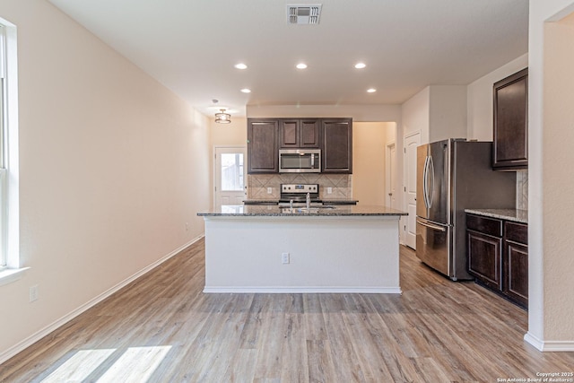 2733 Barkey Spg, San Antonio, TX 78245 - kitchen featuring stainless steel appliances, tasteful backsplash, light wood-type flooring, dark brown cabinets, and recessed lighting