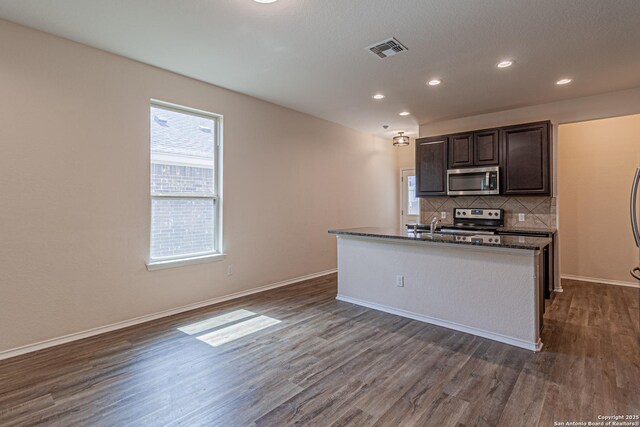 2733 Barkey Spg, San Antonio, TX 78245 - kitchen with stainless steel appliances, dark wood-style floors, backsplash, recessed lighting, and baseboards