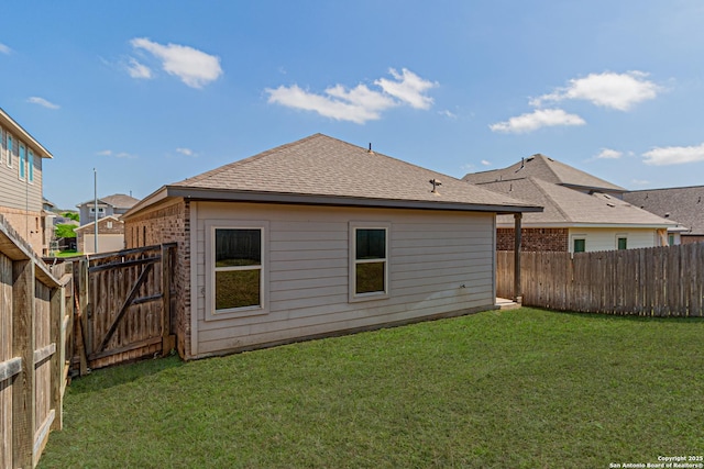 2733 Barkey Spg, San Antonio, TX 78245 - rear view of house with roof with shingles, a gate, and brick siding