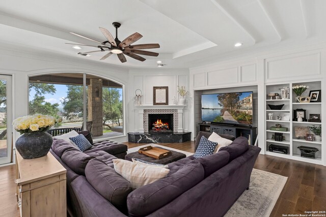 113 Carino Cv, Boerne, TX 78006 - living area with ceiling fan, a tile fireplace, recessed lighting, dark wood-type flooring, and a tray ceiling