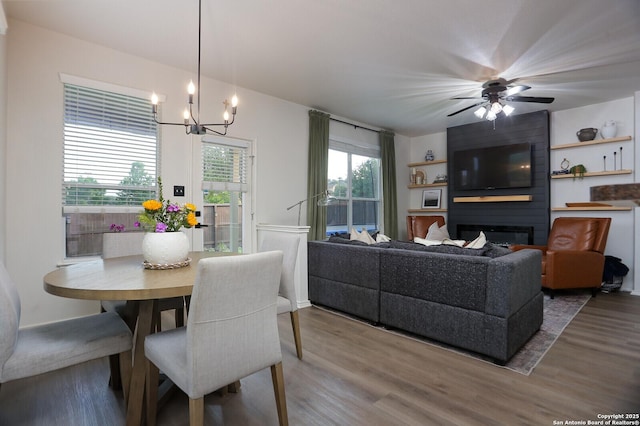 12234 Redbud Leaf, San Antonio, TX 78253 - dining room with wood finished floors, a chandelier, ceiling fan, and a fireplace