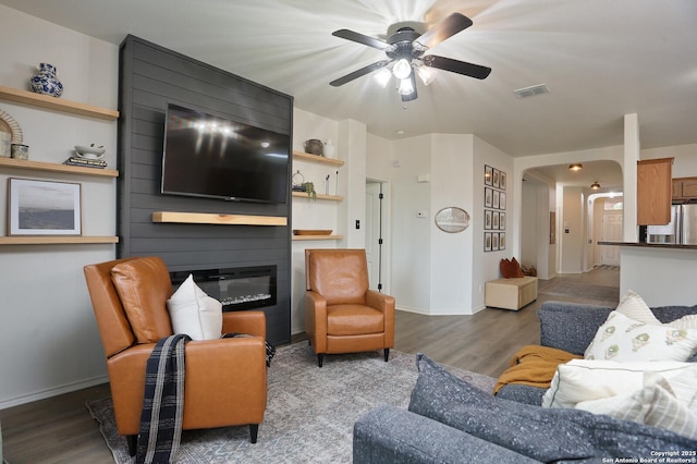 12234 Redbud Leaf, San Antonio, TX 78253 - living room featuring ceiling fan, wood finished floors, a fireplace, arched walkways, and baseboards