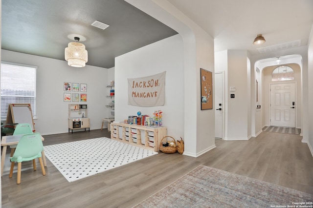 12234 Redbud Leaf, San Antonio, TX 78253 - rec room featuring arched walkways, wood finished floors, plenty of natural light, and baseboards
