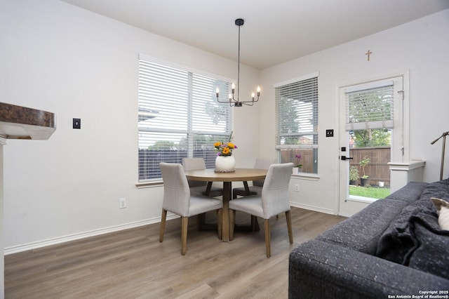 12234 Redbud Leaf, San Antonio, TX 78253 - dining area featuring a chandelier, light wood finished floors, and baseboards