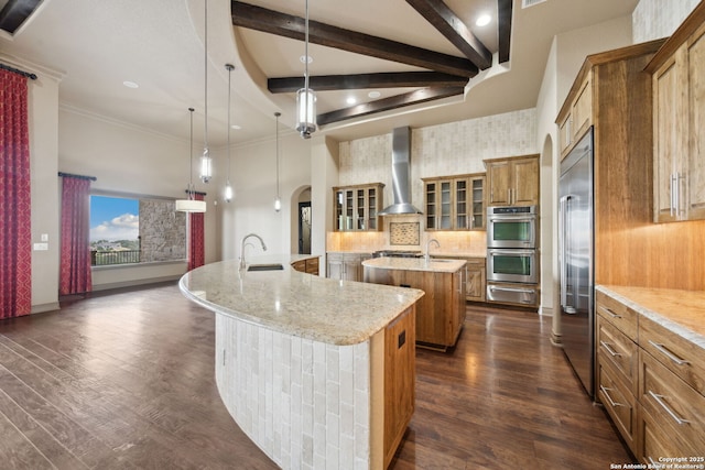 1078 Star Rdg, Spring Branch, TX 78070 - kitchen with a large island with sink, brown cabinetry, wall chimney range hood, a warming drawer, and appliances with stainless steel finishes