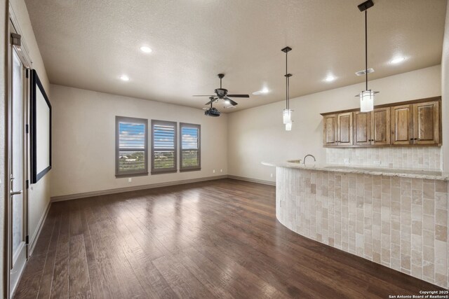 1078 Star Rdg, Spring Branch, TX 78070 - kitchen featuring dark wood finished floors, a ceiling fan, recessed lighting, brown cabinetry, and baseboards